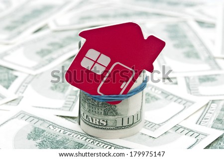 red home sign on hundred dollar bills. Real Estate business Concept