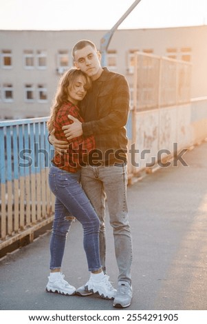 Similar – Image, Stock Photo Couple embracing on bridge under arch with flowers