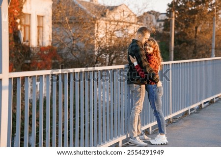Similar – Image, Stock Photo Couple embracing on bridge under arch with flowers