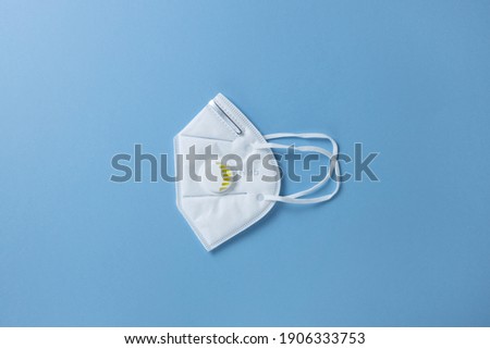 Protective face mask N 95, building respirator with gel filter on pastel blue background, closeup, flatly, minimal. Hygiene concept, prevention of spread of viral infections, health care, harm. Stock foto © 