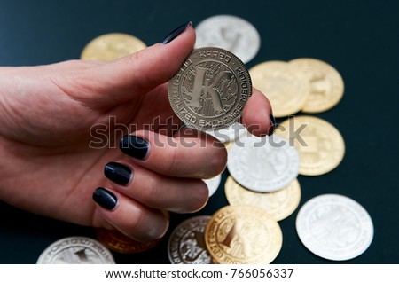 Cryptocurrency coins (Karbo aka Karbovanets) in a hand with manicure Zdjęcia stock © 