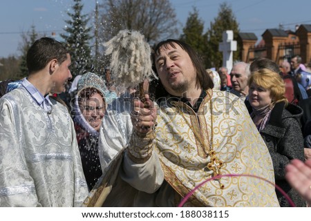 DARNA VILLAGE, ISTRA RAYON, RUSSIA, 2014, APRIL, 19: Orthodox priest father Constantin Volkov with his congregation during ceremony of consecration of Easter eggs and cakes for Easter Christ's
