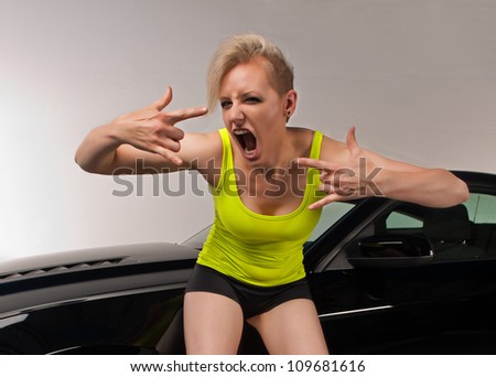 Young woman excited about her car.