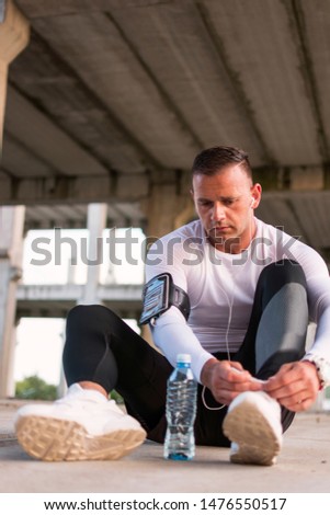 Similar – Foto Bild Seriöser Mann beim Schnüren von Stiefeletten