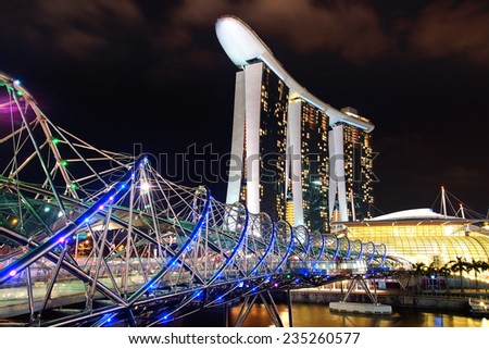 SINGAPORE - FEBRUARY 05, 2014: The Helix Bridge, Marina bay sands at night. Marina Bay Sand iconic design has transformed Singapore\'s skyline. Designed by architect Moshe Safdie.