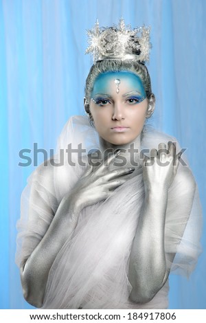 Model posing with creative make up and body painting as Ice Queen
