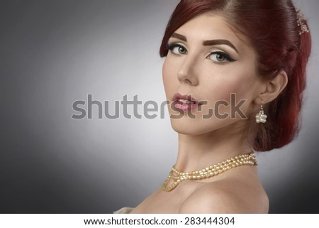 Close up portrait of an elegant young woman with bridal make up and hairstyle