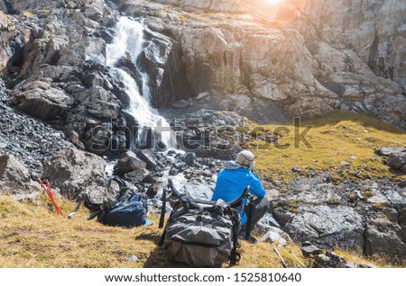 Similar – Image, Stock Photo Anonymous man enjoying mountain landscape and lake