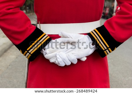 hands of a royal guard wearing white gloves