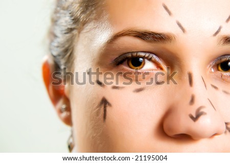 Closeup portrait of a pretty Caucasian woman\'s face marked with lines for facial cosmetic surgery