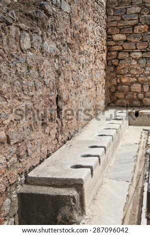 Public multi-seat toilet at spectacular, well restored, antique ruins in Ephesus, Turkey