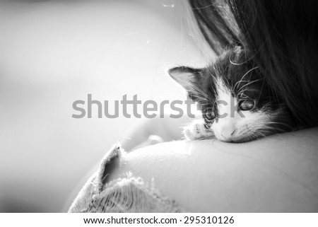 Fearful kitten was comforting by a woman on her shoulder, Vintage Style, Soft & Dreamy Effect, Low Clarity, black&white