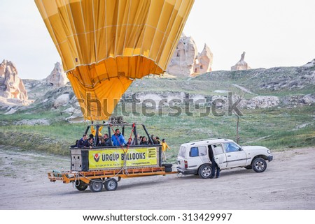 GOREME, TURKEY - APRIL 13, 2014, Cappadocia, Turkey. The hot air balloon landing on a dirt road, Cappadocia, Turkey.