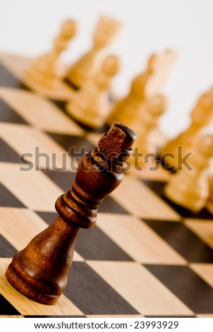 Chess on white - lonely black king against whites