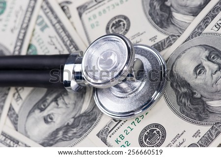 Stethoscope on one hundred US dollar bills.