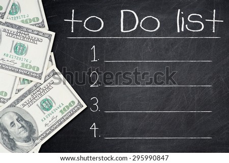 TO DO LIST text written on a chalkboard with a number of one hundred US dollar notes