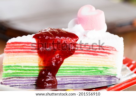 rainbow cake topping with pink hart.