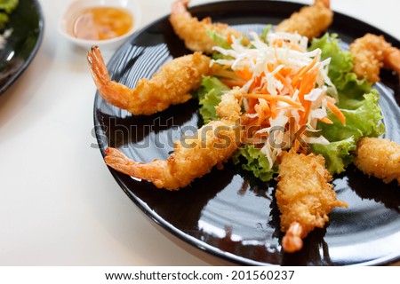fried shrimp tempura with vegetables on plate.