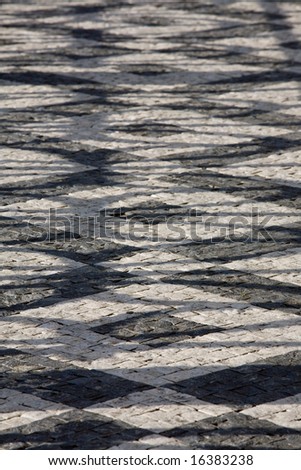 Cube stone structure of Prague pavement with shadows. Background texture.