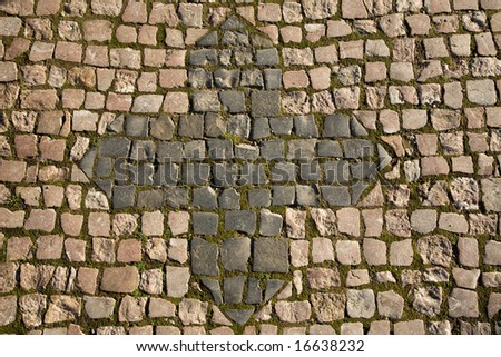 Cube stone structure with cross symbol of Prague pavement. Background texture.