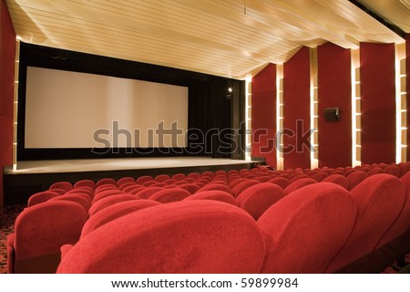Empty cinema auditorium with line of chairs and projection screen. Ready for adding your own picture. Side view.