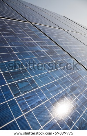 Solar power plant panels with sun reflection.