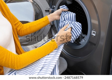 Similar – Image, Stock Photo Getting laundry out of the washing machine