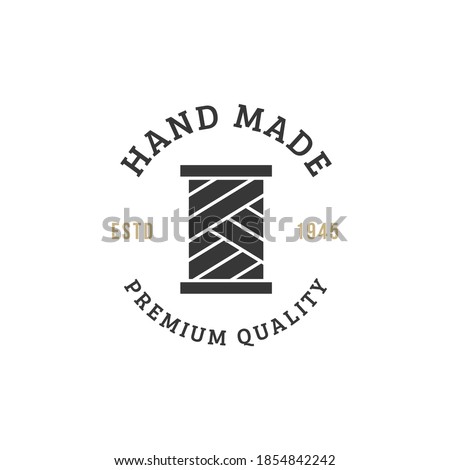 Emblem of hand made concept with thread spool icon Premium Vector. Yarn spool  logo.