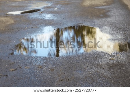 Similar – Foto Bild Pfützen auf einer Landstraße nach Regenfällen. Schwarz und weiß düstere Landschaft Szene