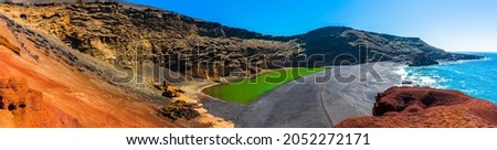 Majestic panorama of volcanic green lake (El Lago Verde), black sand beach and the corroded volcano crater walls in black, grey, and red. El Golfo, Lanzarote, Canaries Islands, Spain. Stock foto © 