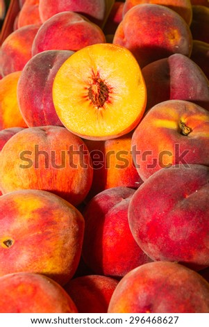 High energy food, health booster super fruit, juicy peaches on an open air fruit market bazaar.
