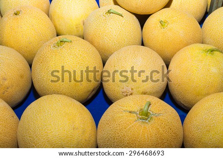 High energy food, health booster super fruit yellow melon on an open air fruit market stand.