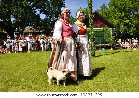 TORSTUNA, SWEDEN - JUNE 22: Unidentified people in folklore ensemble in traditional folk costume. The official name is midsummer event and org are hembygd Torstuna on June 22, 2012 in Torstuna Sweden