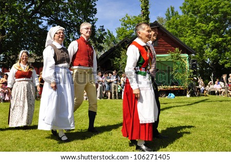 TORSTUNA, SWEDEN - JUNE 22: Unidentified people in folklore ensemble in traditional folk costume. The official name is midsummer event and org are hembygd Torstuna on June 22, 2012 in Torstuna Sweden