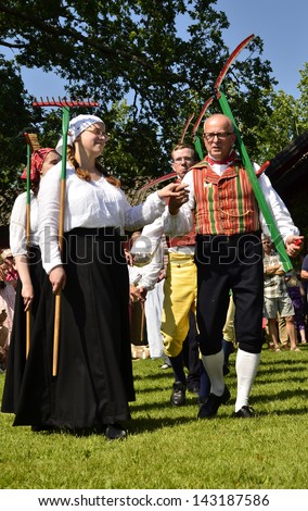 TORSTUNA,SWEDEN - JUNE 21: Unidentified people in folklore ensemble in midsummer event. The official name is midsummer event and organization are hembygd Torstuna on June 21, 2013 in Torstuna Sweden
