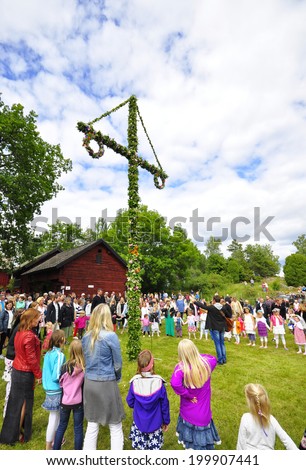 TORSTUNA, SWEDEN - JUNE 20: Unidentified people dancing around the maypole in midsummer . The official name is midsummer event and organization are hembygd Torstuna on June 20, 2014 in Torstuna Sweden