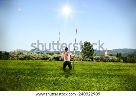 Man Standing Alone on Grass Field is Taking a Ropes from Heaven