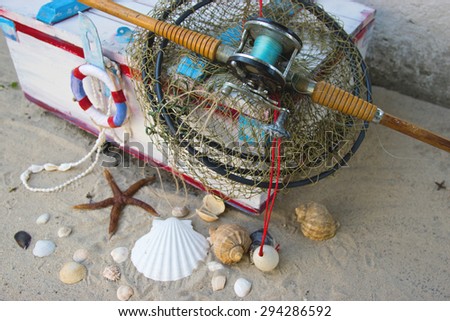 Fisherman Still Life with Net , Fishing Rods and Shells on Sand