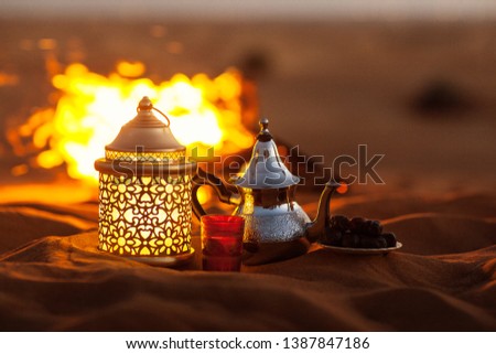 Similar – Image, Stock Photo Dates, teapot, cup with tea near the fire in the desert with a beautiful background