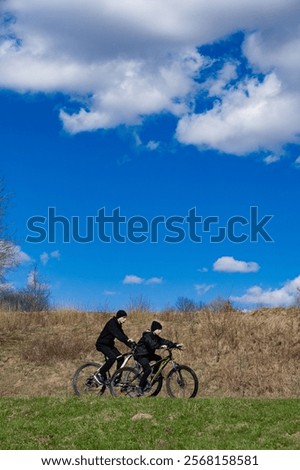 Similar – Image, Stock Photo Cyclist appears on the line from the airfield