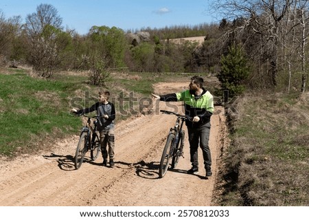 Similar – Image, Stock Photo Man cycling on sandy beach hill