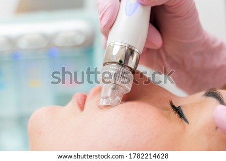 Beauty salon. The cosmetologist makes a water peeling procedure for the client. Close up of face and device. The concept of professional skin care Foto stock © 