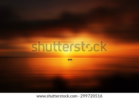 Man riding boat.Photo has motion blur effect added on the sky and beach