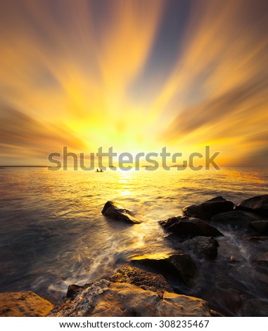 Beautiful scenery of sunset beach in Borneo .Warmer color of sunset.Long exposure of the sky.