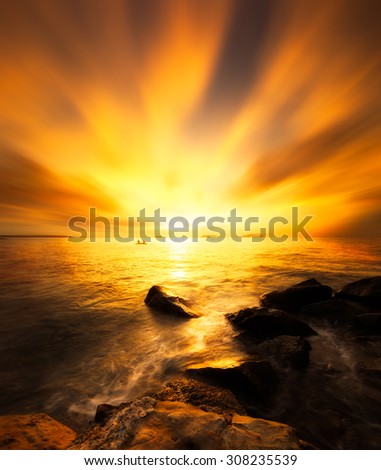 Beautiful scenery of sunset beach in Borneo .Warmer color of sunset and photo have soft contrast.Long exposure of the sky.