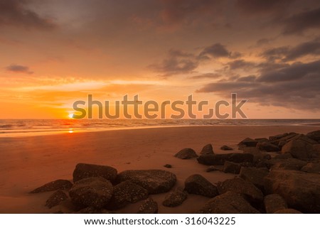 Beautiful golden hour sunset scenery over the beach.