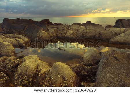 Reflection of sunset sky in the water stagnant over the rock formation. Image are taken in Sabah,Borneo.