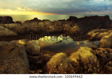 Reflection of sunset sky in the water stagnant over the rock formation. Image are taken in Sabah,Borneo.