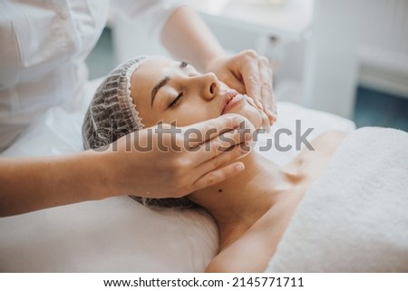 Facial skin treatment. Girl facial treatment. Facial skincare. Spa body care.Close up portrait of beautician's hands cleaning female face with cotton pads at Foto d'archivio © 