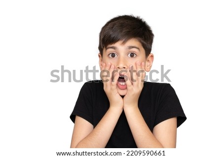 Little boy asian kid wearing casual black tshirt scared and amazed with open mouth for surprise, disbelief face. Isolated on the white background Сток-фото © 